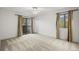 Bright bedroom features neutral carpet, ceiling fan, and sliding doors to outside at 3050 W 32Nd Ave # 104C, Denver, CO 80211