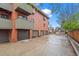 Exterior view of condo building with garages and balconies at 3050 W 32Nd Ave # 104C, Denver, CO 80211