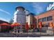 Charming outdoor space with orange umbrellas located at Little Personal Ice Cream shop for customers to enjoy at 3050 W 32Nd Ave # 104C, Denver, CO 80211