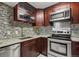 Kitchen featuring stainless steel appliances, granite countertops and mosaic tile backsplash at 3050 W 32Nd Ave # 104C, Denver, CO 80211