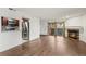 Living room with hardwood floors, fireplace, sliding doors to balcony, and view into kitchen at 3050 W 32Nd Ave # 104C, Denver, CO 80211
