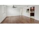 Spacious living room features ceiling fan, hardwood floors, and view into kitchen at 3050 W 32Nd Ave # 104C, Denver, CO 80211