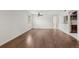 Living room featuring hardwood floors, ceiling fan, and view into kitchen at 3050 W 32Nd Ave # 104C, Denver, CO 80211