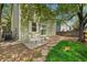 Cozy patio with table and chairs next to a grassy backyard at 4267 W Kenyon Ave, Denver, CO 80236