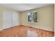 Bright bedroom featuring wood floors, a window with natural light, and a closet at 4267 W Kenyon Ave, Denver, CO 80236