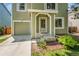View of the home's entrance, showcasing the front door, driveway, and a portion of the landscaped yard at 4267 W Kenyon Ave, Denver, CO 80236