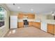 Bright kitchen features wooden cabinets, stainless steel appliances, and a window for natural light at 4267 W Kenyon Ave, Denver, CO 80236
