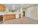 Open kitchen features bright countertops and wooden cabinets; offers views of the living room at 4267 W Kenyon Ave, Denver, CO 80236