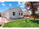 Scenic backyard featuring a well-kept lawn, water feature and light blue siding at 5740 S Tempe Ct, Aurora, CO 80015