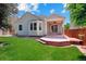 Picturesque backyard featuring a covered patio, well-kept lawn, and blue skies at 5740 S Tempe Ct, Aurora, CO 80015