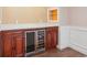 Close up of basement bar cabinets, counter tops, and beverage refrigerator at 5740 S Tempe Ct, Aurora, CO 80015