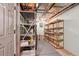 Unfinished basement area with shelving for storage, offering ample space at 5740 S Tempe Ct, Aurora, CO 80015