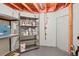 Unfinished basement storage area with shelving at 5740 S Tempe Ct, Aurora, CO 80015