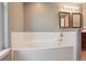 A pristine bathroom features a large soaking tub and a double vanity at 5740 S Tempe Ct, Aurora, CO 80015