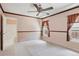 Bright bedroom with carpet, decorative wood trim, ceiling fan, and ensuite bathroom at 5740 S Tempe Ct, Aurora, CO 80015