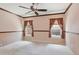Spacious bedroom with neutral walls, carpet floors, and windows with wood trim and ceiling fan at 5740 S Tempe Ct, Aurora, CO 80015