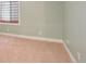 Light-filled bedroom with neutral carpet, base trim and a window with horizontal blinds at 5740 S Tempe Ct, Aurora, CO 80015