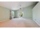 Spacious bedroom with a vaulted ceiling, fan, and access to an outdoor patio at 5740 S Tempe Ct, Aurora, CO 80015