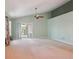 Bright and airy bedroom with neutral carpet, a ceiling fan, and sliding glass doors to the backyard at 5740 S Tempe Ct, Aurora, CO 80015