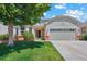 Charming home with well-maintained lawn, mature tree, and an attached garage at 5740 S Tempe Ct, Aurora, CO 80015