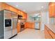 Bright kitchen featuring stainless steel appliances, wood cabinets, and neutral countertops at 5740 S Tempe Ct, Aurora, CO 80015