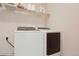 Bright laundry area featuring a modern washer and dryer set with shelving at 5740 S Tempe Ct, Aurora, CO 80015