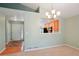 Open-concept living room and kitchen area with light green walls and wood flooring at 5740 S Tempe Ct, Aurora, CO 80015