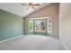 A spacious main bedroom boasts a vaulted ceiling, ceiling fan, and a bay window with natural light at 5740 S Tempe Ct, Aurora, CO 80015