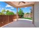 Covered patio with ceiling fan overlooking a fenced yard and blue skies at 5740 S Tempe Ct, Aurora, CO 80015