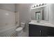 Updated bathroom with a dark vanity, marble countertop, and tiled shower/tub combo at 3233 Vallejo St # 3B, Denver, CO 80211