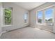 Well-lit bedroom with neutral carpeting and large windows at 3233 Vallejo St # 3B, Denver, CO 80211