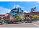 Modern building with street-level businesses and parking at 3233 Vallejo St # 3B, Denver, CO 80211