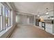 Open living room and kitchen with large windows and neutral carpeting at 3233 Vallejo St # 3B, Denver, CO 80211