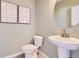 Stylish half bathroom with modern fixtures, round mirror, and elegant decor at 1751 Peak Loop, Broomfield, CO 80023