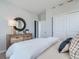 Bedroom featuring a stylish dresser, modern round mirror, and sliding door closet at 1751 Peak Loop, Broomfield, CO 80023