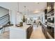 Modern kitchen featuring a large center island, sleek cabinetry, and open access to the living and dining areas at 1751 Peak Loop, Broomfield, CO 80023