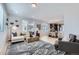 Open concept living room with stylish furnishings seamlessly connects to the dining and kitchen areas at 1751 Peak Loop, Broomfield, CO 80023