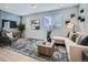 Bright living room with neutral color palette, modern furnishings and large windows offering ample natural light at 1751 Peak Loop, Broomfield, CO 80023