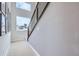 Modern staircase featuring carpeted steps, gray walls, and natural light from a window at 1751 Peak Loop, Broomfield, CO 80023
