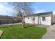 Spacious backyard with green lawn and a mature birch tree at 4910 Alcott St, Denver, CO 80221