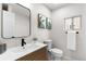 Modern bathroom featuring a sink, toilet and decorative art at 4910 Alcott St, Denver, CO 80221