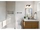 Modern bathroom featuring a sink, toilet and a stand up shower with updated tile at 4910 Alcott St, Denver, CO 80221