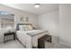 Bright bedroom features a bed, bench, side tables, and large window at 4910 Alcott St, Denver, CO 80221