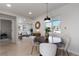 Open-concept dining area flowing into living room, filled with natural light at 4910 Alcott St, Denver, CO 80221