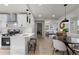 Open concept kitchen featuring a breakfast bar and views into the dining and living areas at 4910 Alcott St, Denver, CO 80221