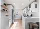 Open white kitchen with stainless steel appliances and view of the kitchen island at 4910 Alcott St, Denver, CO 80221