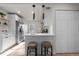 Kitchen with island, stainless steel appliances and floating shelves at 4910 Alcott St, Denver, CO 80221