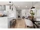 Open kitchen and dining area, with breakfast bar and sightlines to the living room at 4910 Alcott St, Denver, CO 80221