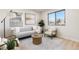 Bright living room features a comfortable sofa, chairs, decorative rug, and stylish coffee table at 4910 Alcott St, Denver, CO 80221