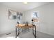Bright office features a modern desk, decor, large window and neutral carpet at 4910 Alcott St, Denver, CO 80221